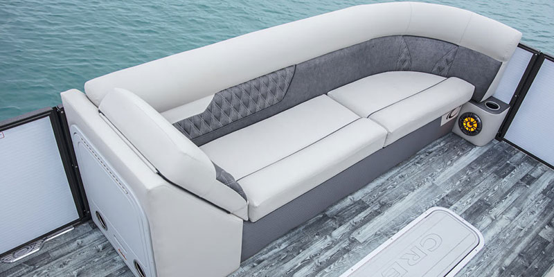 couch and speaker inside the crest pontoon boat rental
